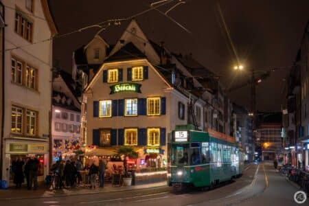 Une des rames anciennes du tramway de Bâle au pied d'une maison bien décorée